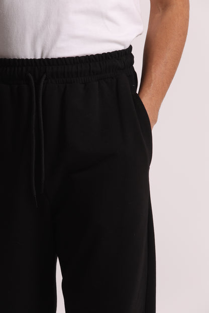 PANTALONI TUTA A GAMBA LARGA